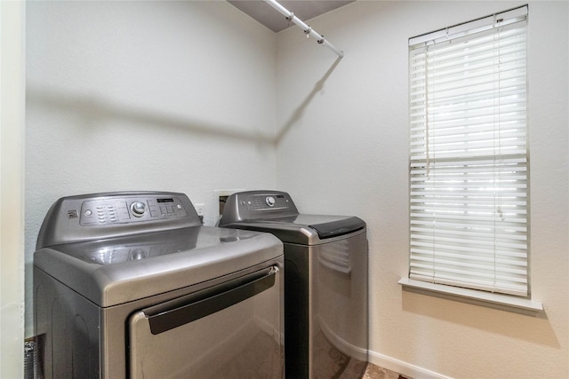 clothes washing area with separate washer and dryer