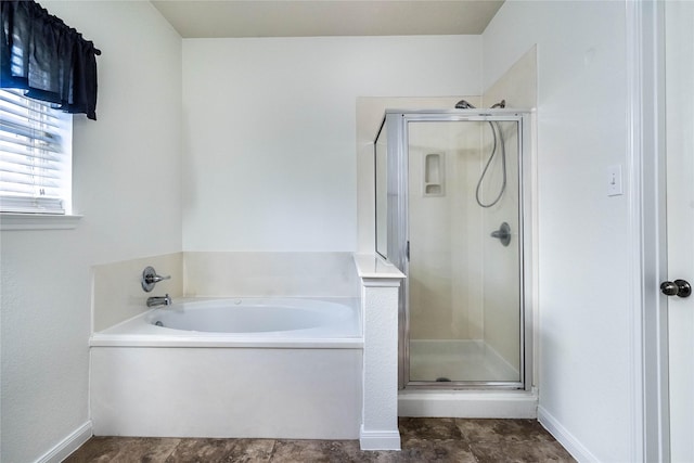 bathroom featuring shower with separate bathtub