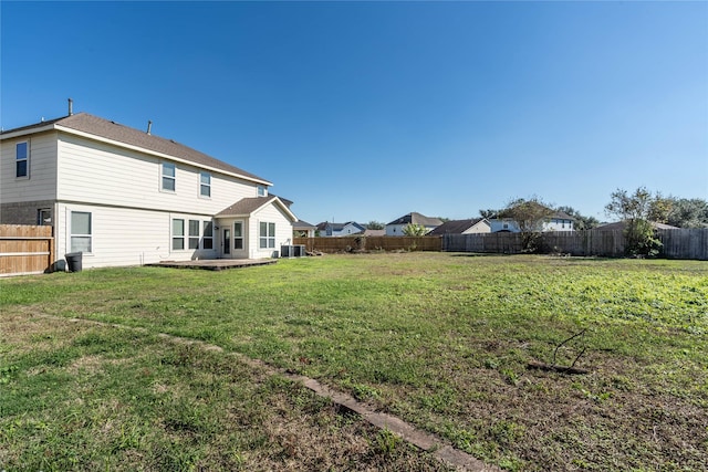 back of house featuring a yard, a patio, and central air condition unit