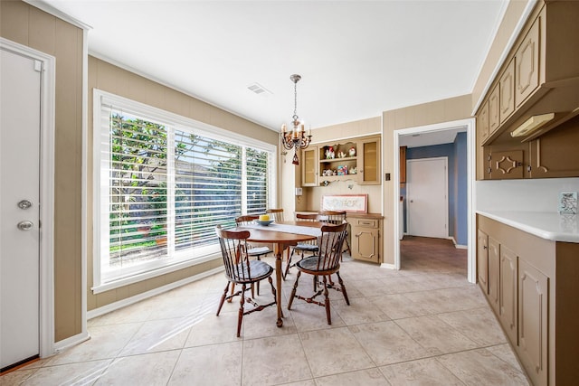 dining space with light tile patterned flooring and a chandelier