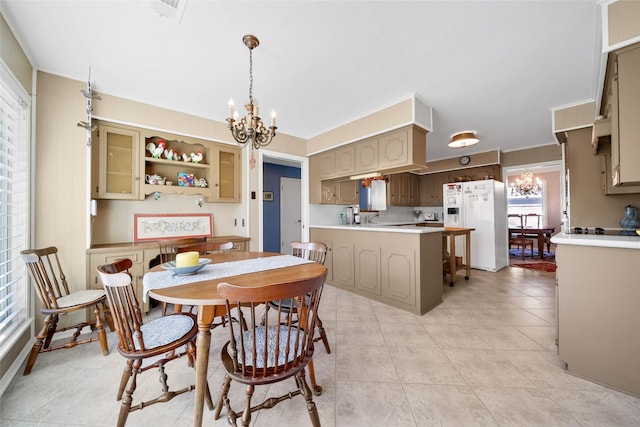 dining space featuring a notable chandelier and light tile patterned flooring