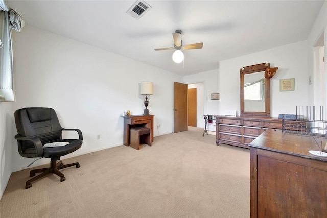 office space featuring light carpet and ceiling fan