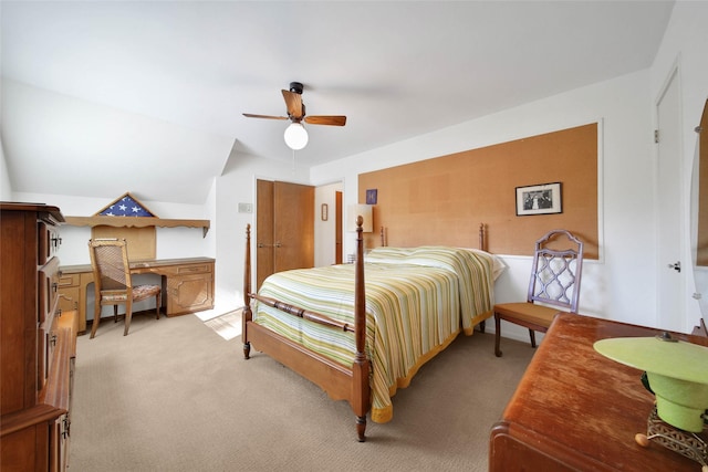 carpeted bedroom featuring ceiling fan, built in desk, and lofted ceiling