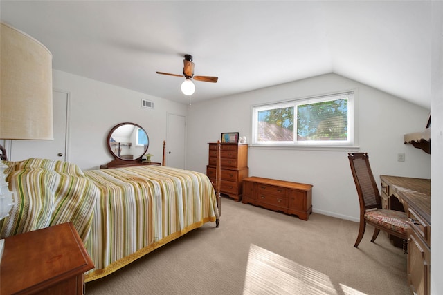 bedroom with light colored carpet, vaulted ceiling, and ceiling fan