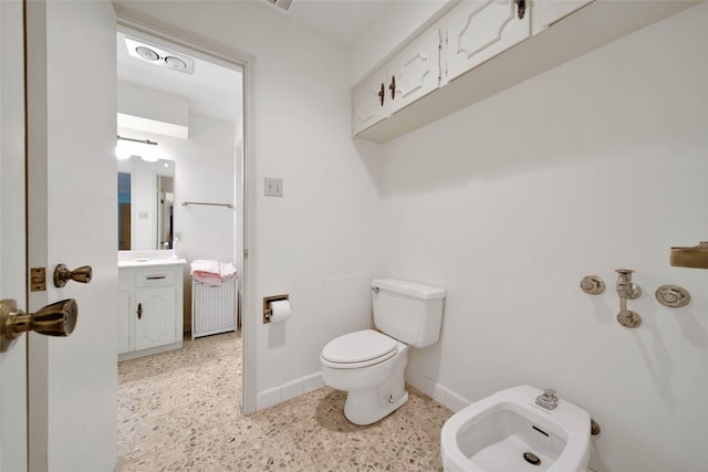 bathroom featuring vanity, a bidet, and toilet