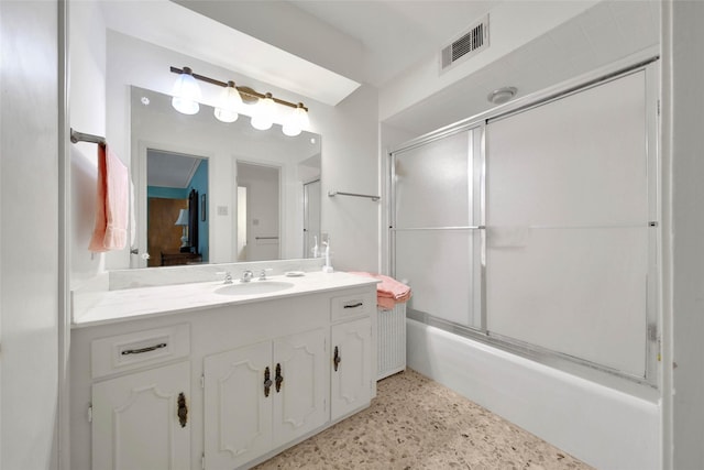 bathroom featuring vanity and bath / shower combo with glass door