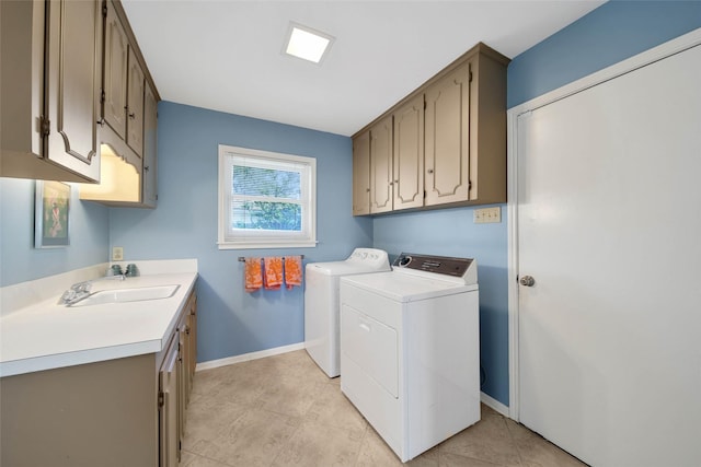 laundry area featuring cabinets, independent washer and dryer, and sink