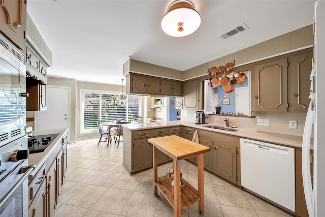 kitchen featuring dishwasher, sink, kitchen peninsula, black electric cooktop, and light tile patterned floors