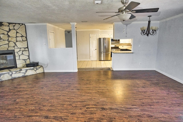 unfurnished living room with a textured ceiling, crown molding, wood-type flooring, and a fireplace