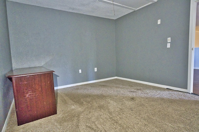 empty room featuring carpet floors and a textured ceiling