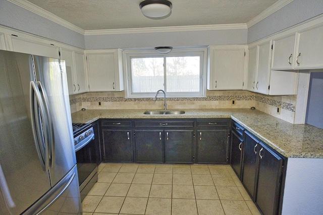 kitchen featuring sink, light stone countertops, tasteful backsplash, white cabinetry, and stainless steel appliances