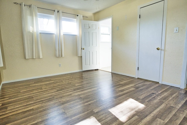 unfurnished bedroom with dark hardwood / wood-style floors