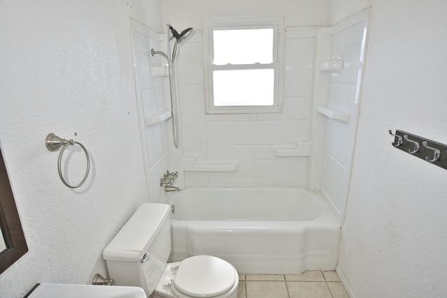 bathroom featuring tile patterned flooring, bathing tub / shower combination, and toilet