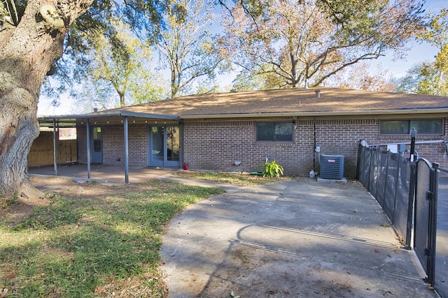 back of property with a patio area and central AC unit