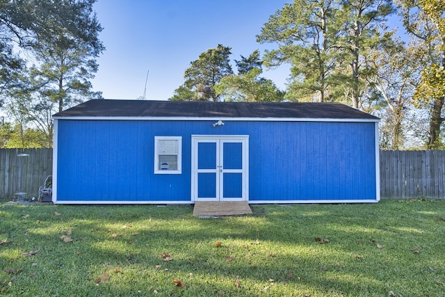 view of outbuilding featuring a lawn