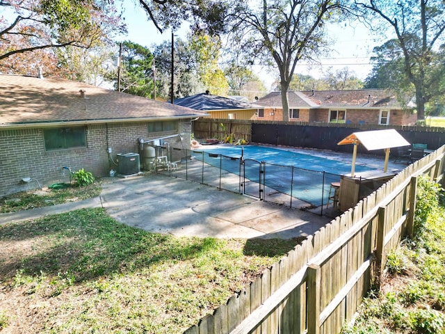 view of pool with a patio area and central AC unit