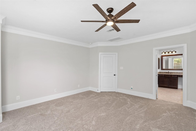 unfurnished bedroom with light carpet, ensuite bathroom, ceiling fan, and ornamental molding