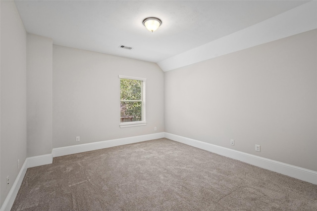 empty room with carpet and lofted ceiling