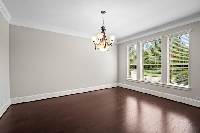 empty room featuring ornamental molding, an inviting chandelier, and dark wood-type flooring