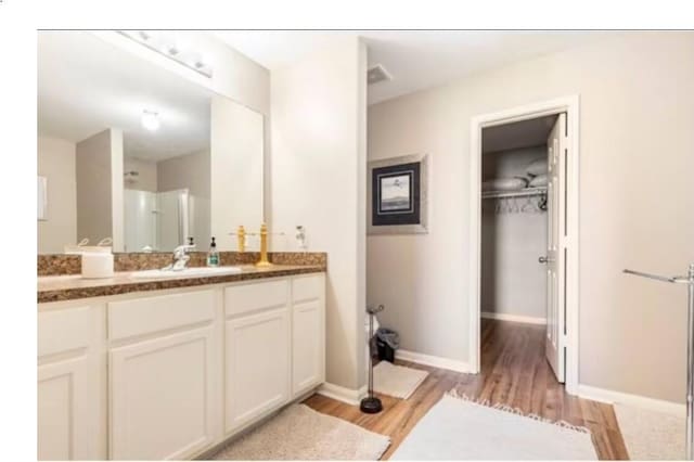 bathroom featuring hardwood / wood-style floors and vanity