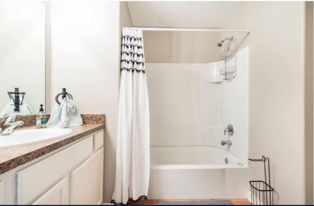 bathroom with shower / tub combo and vanity