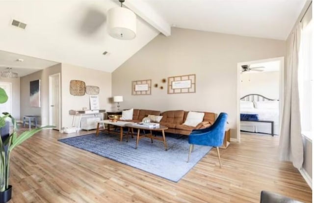 living room featuring ceiling fan, beam ceiling, high vaulted ceiling, and light hardwood / wood-style flooring