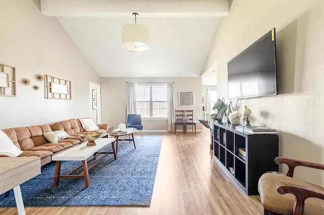 living room with hardwood / wood-style floors, beamed ceiling, and high vaulted ceiling