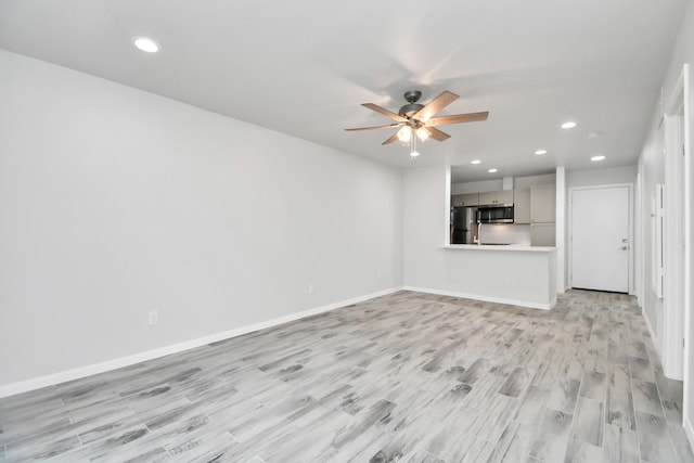 unfurnished living room with light hardwood / wood-style floors and ceiling fan