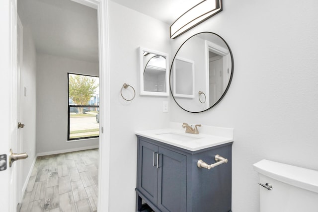 bathroom featuring hardwood / wood-style floors, vanity, and toilet