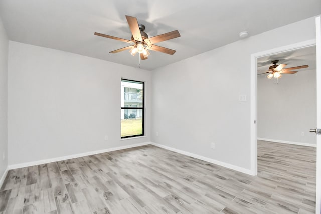 empty room featuring ceiling fan and light hardwood / wood-style floors