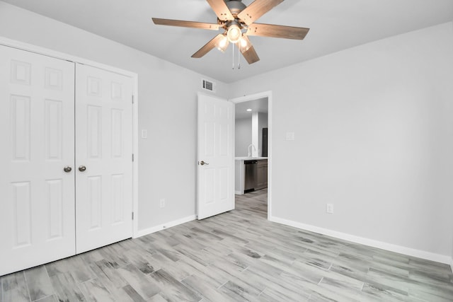 unfurnished bedroom featuring ceiling fan, a closet, and light hardwood / wood-style flooring