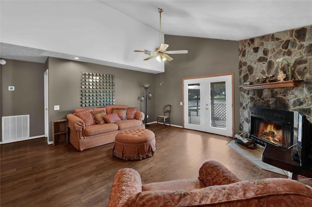 living room featuring french doors, ceiling fan, hardwood / wood-style flooring, high vaulted ceiling, and a fireplace