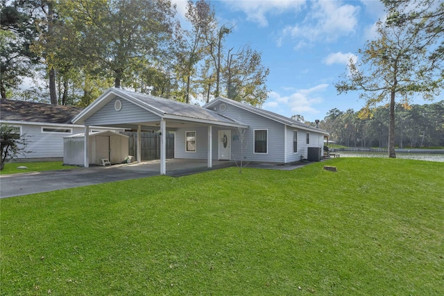 ranch-style home with a water view, central AC, and a front lawn