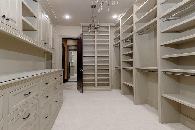 walk in closet with light colored carpet and a notable chandelier