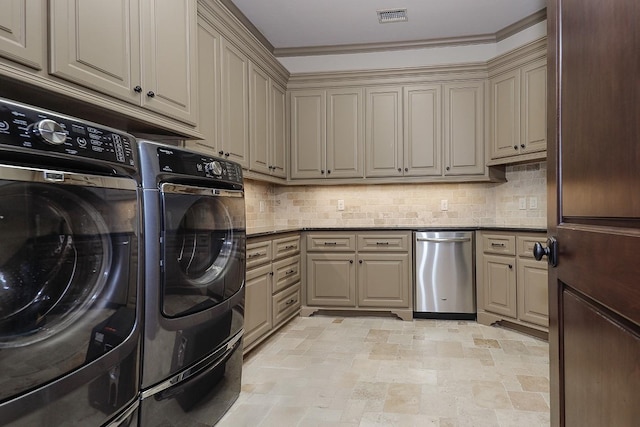 laundry area with washer and dryer, cabinets, and ornamental molding