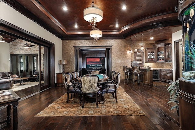 dining space featuring ceiling fan, wine cooler, dark hardwood / wood-style flooring, bar area, and ornamental molding