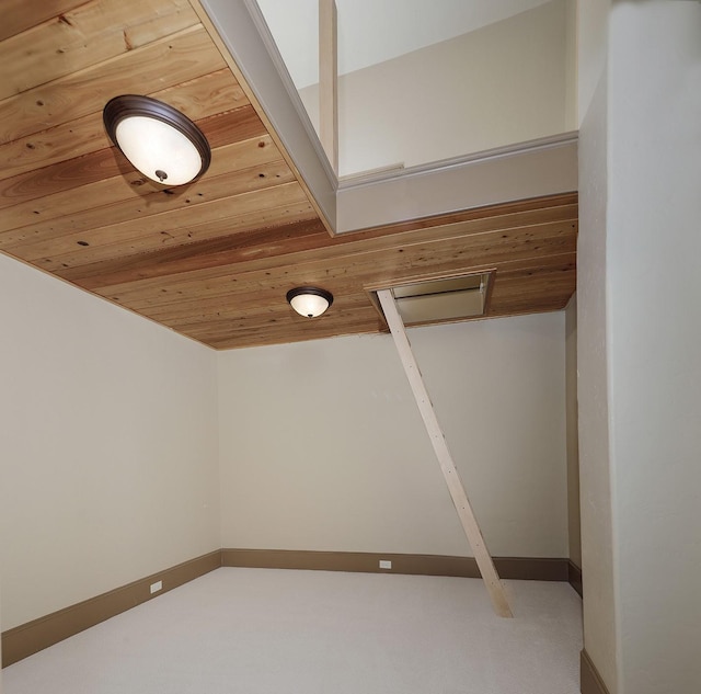 interior space featuring carpet flooring and wood ceiling