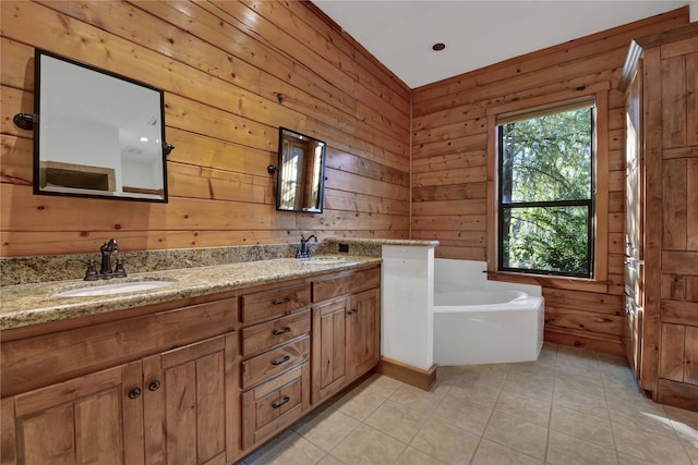 bathroom featuring a washtub, vanity, tile patterned flooring, and wooden walls