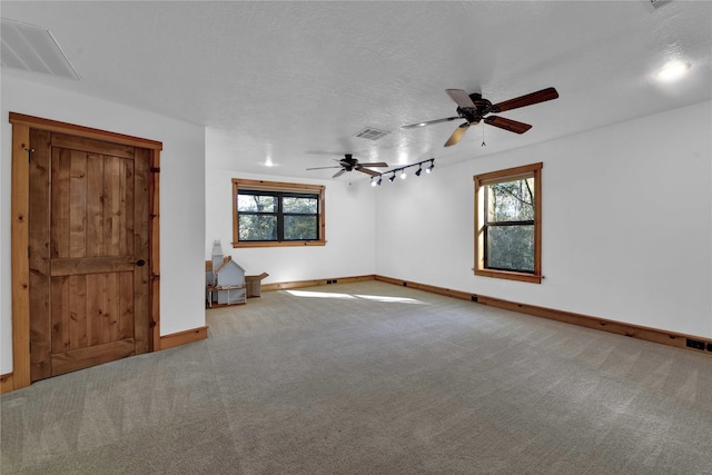 unfurnished room featuring ceiling fan, carpet, and a textured ceiling