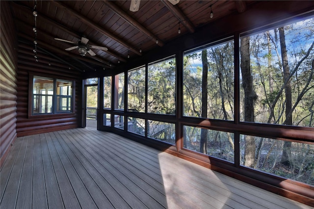 unfurnished sunroom featuring lofted ceiling with beams, ceiling fan, and wood ceiling