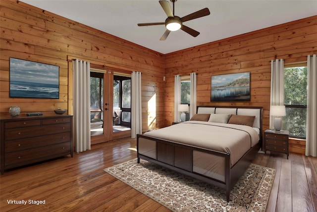 bedroom featuring hardwood / wood-style floors, ceiling fan, access to exterior, and french doors