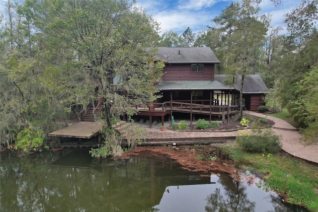 back of house featuring a deck with water view