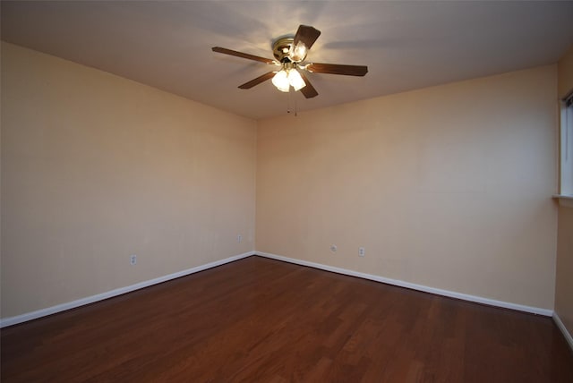 empty room with dark hardwood / wood-style floors and ceiling fan