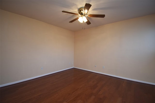 spare room featuring dark hardwood / wood-style floors and ceiling fan