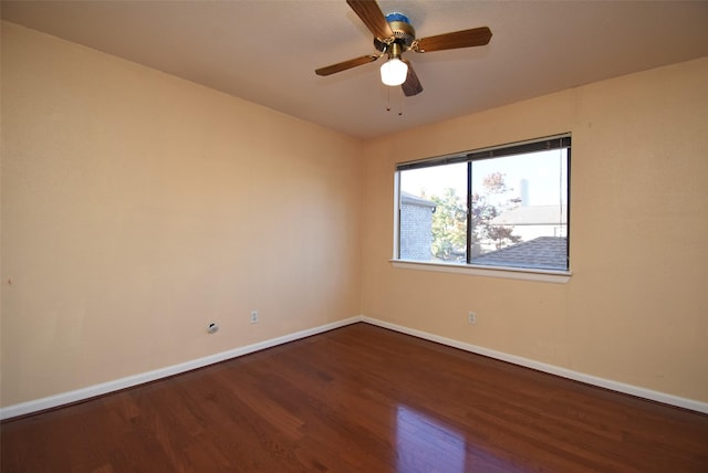 empty room with ceiling fan and dark wood-type flooring