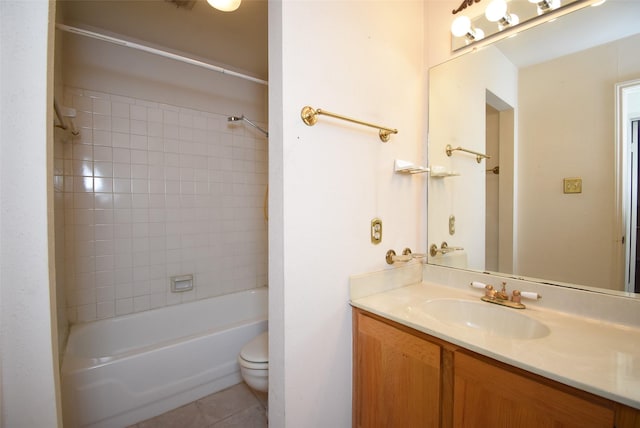 full bathroom featuring tile patterned flooring, vanity, toilet, and tiled shower / bath combo