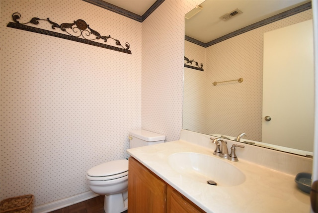 bathroom featuring hardwood / wood-style floors, vanity, toilet, and crown molding