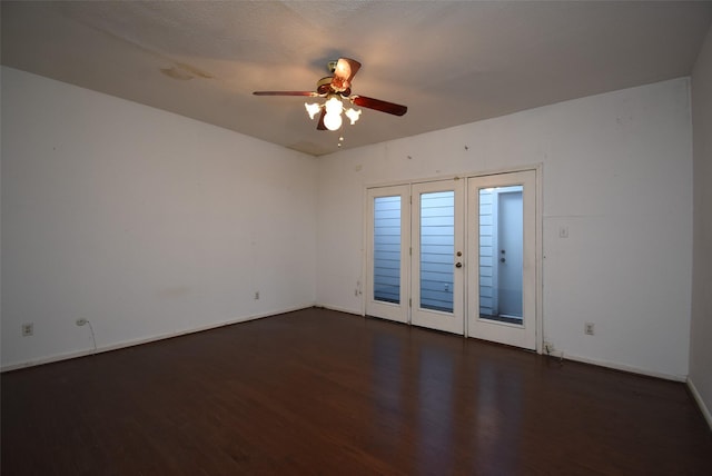 spare room featuring dark hardwood / wood-style floors, ceiling fan, a textured ceiling, and french doors