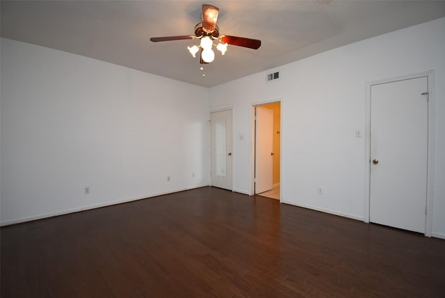 unfurnished room with a textured ceiling, ceiling fan, and dark wood-type flooring