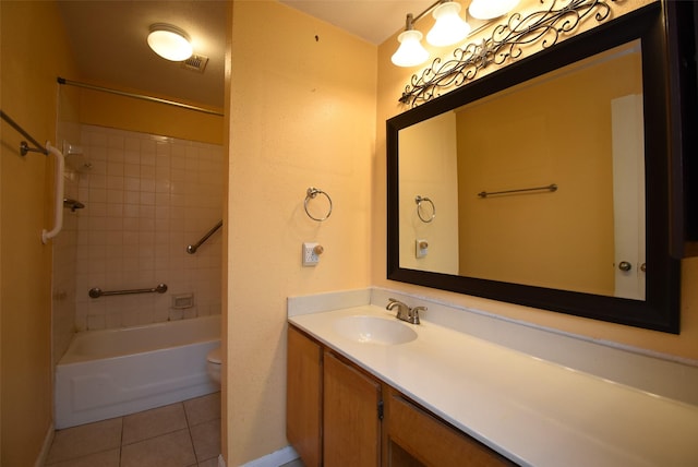 full bathroom featuring tile patterned floors, vanity, toilet, and tiled shower / bath